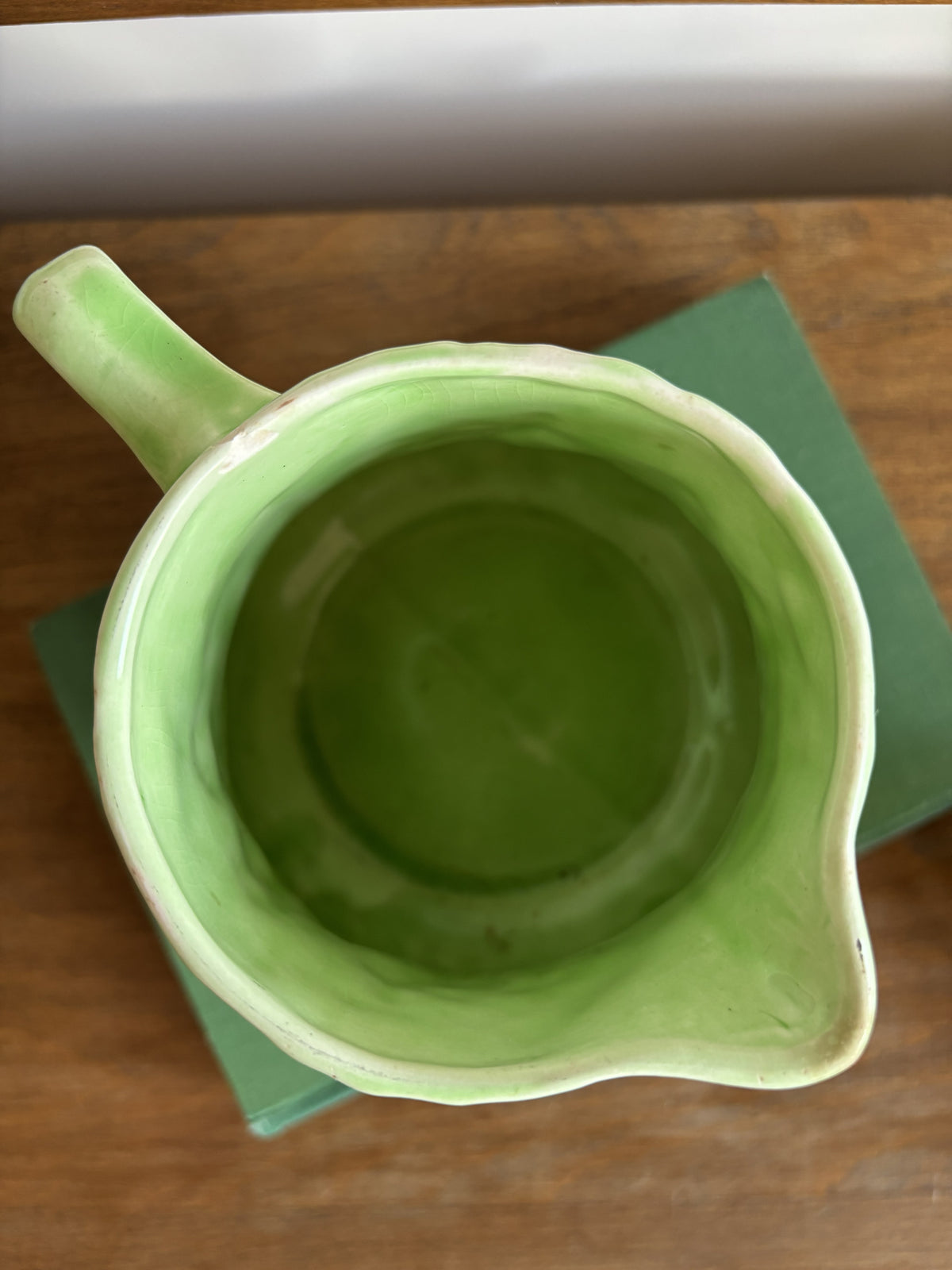 The inside of an English Majolica style green cabbage leaf textured jug.  