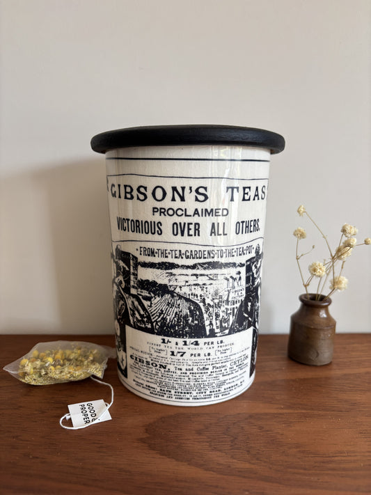 A vintage Crown Devon white ceramic storage jar with black transferware advertising Gibson's Tea.  