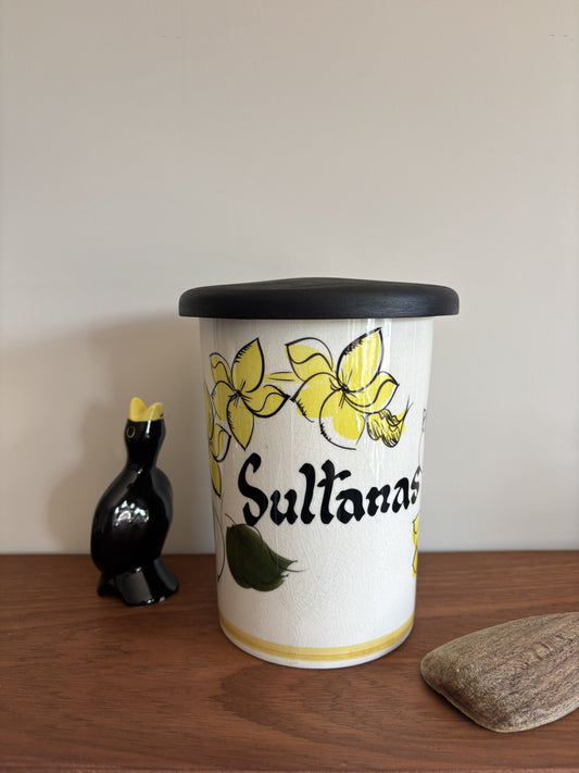 A vintage Toni Raymond Ceramic Storage jar. Featuring yellow flowers and the words Sultanas in black lettering on the front.  