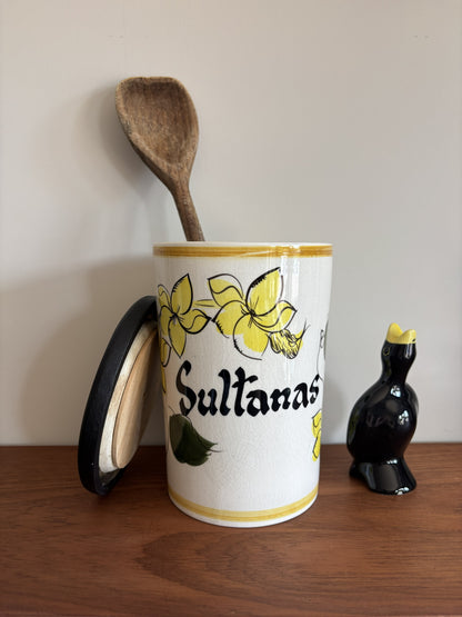 A vintage Toni Raymond Ceramic Storage jar. Featuring yellow flowers and the words Sultanas in black lettering on the front.  