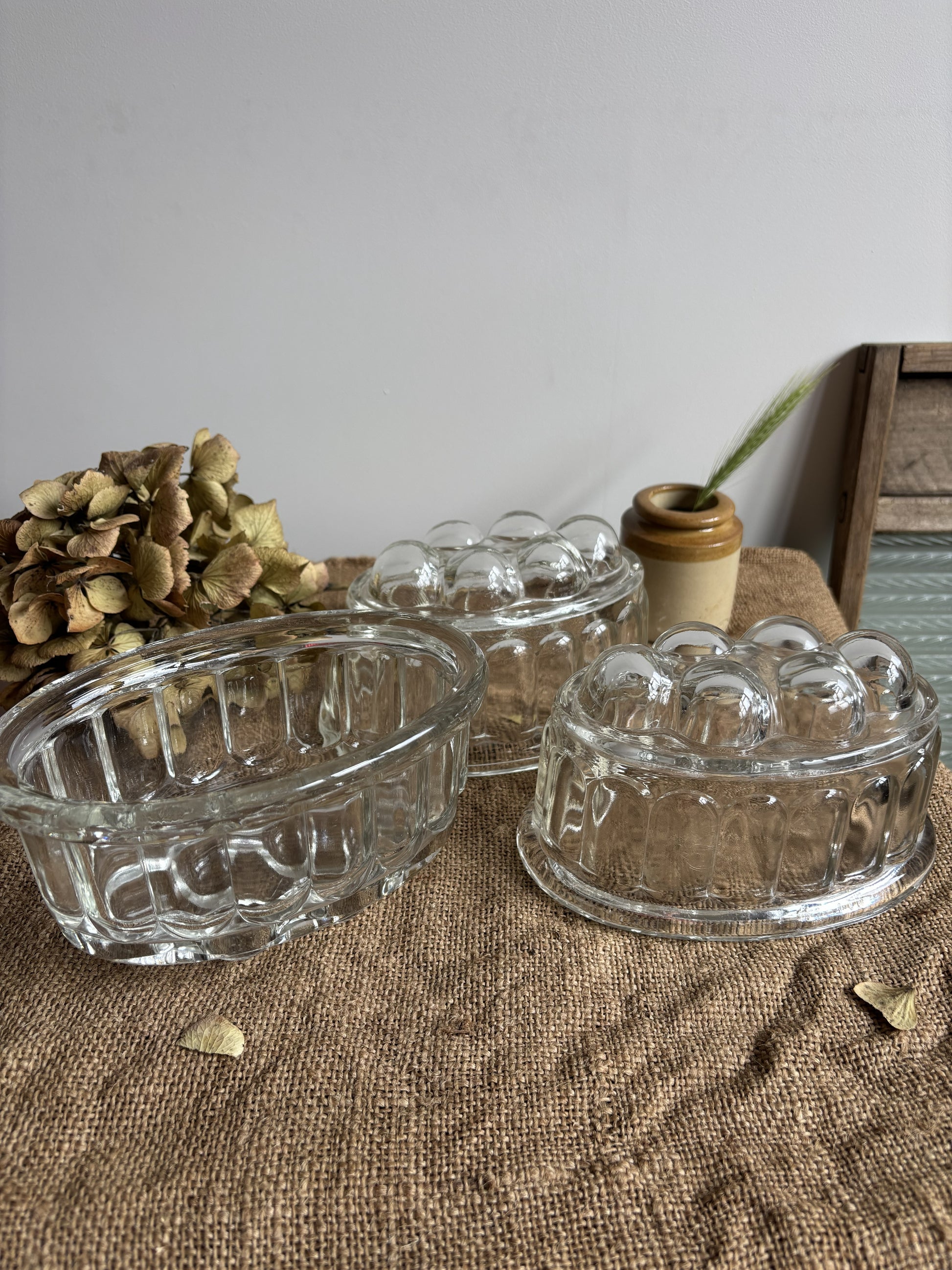 Three clear glass bowls on a textured surface with a neutral background