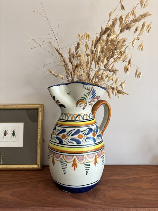A large Spanish stoneware pitcher featuring vibrant colourful motifs  