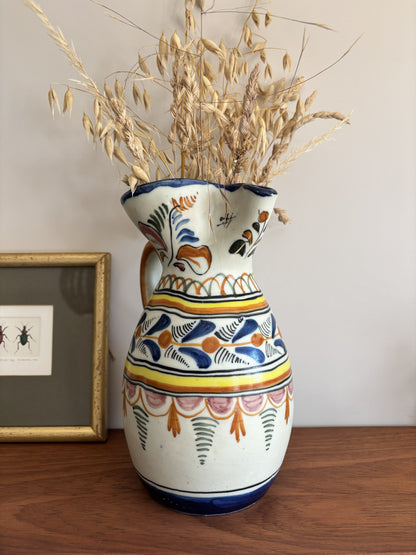 A large Spanish stoneware pitcher featuring vibrant colourful motifs 