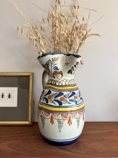 A large Spanish stoneware pitcher featuring vibrant colourful motifs 