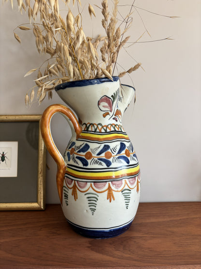 A large Spanish stoneware pitcher featuring vibrant colourful motifs 
