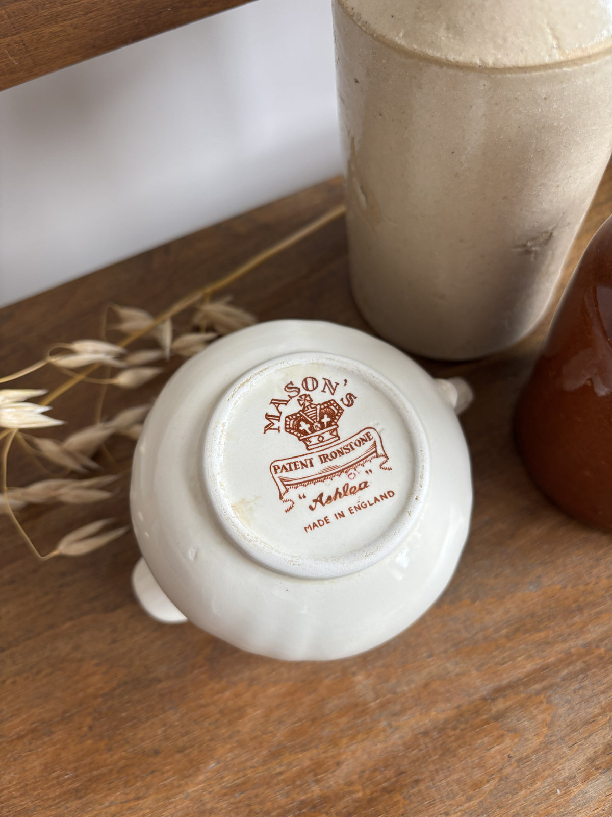 The base of a cream-colored Mason's ceramic creamer pitcher displaying the maker's mark