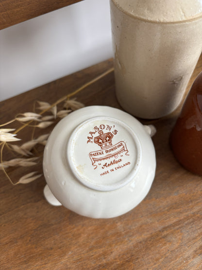 The base of a cream-colored Mason's ceramic creamer pitcher displaying the maker's mark