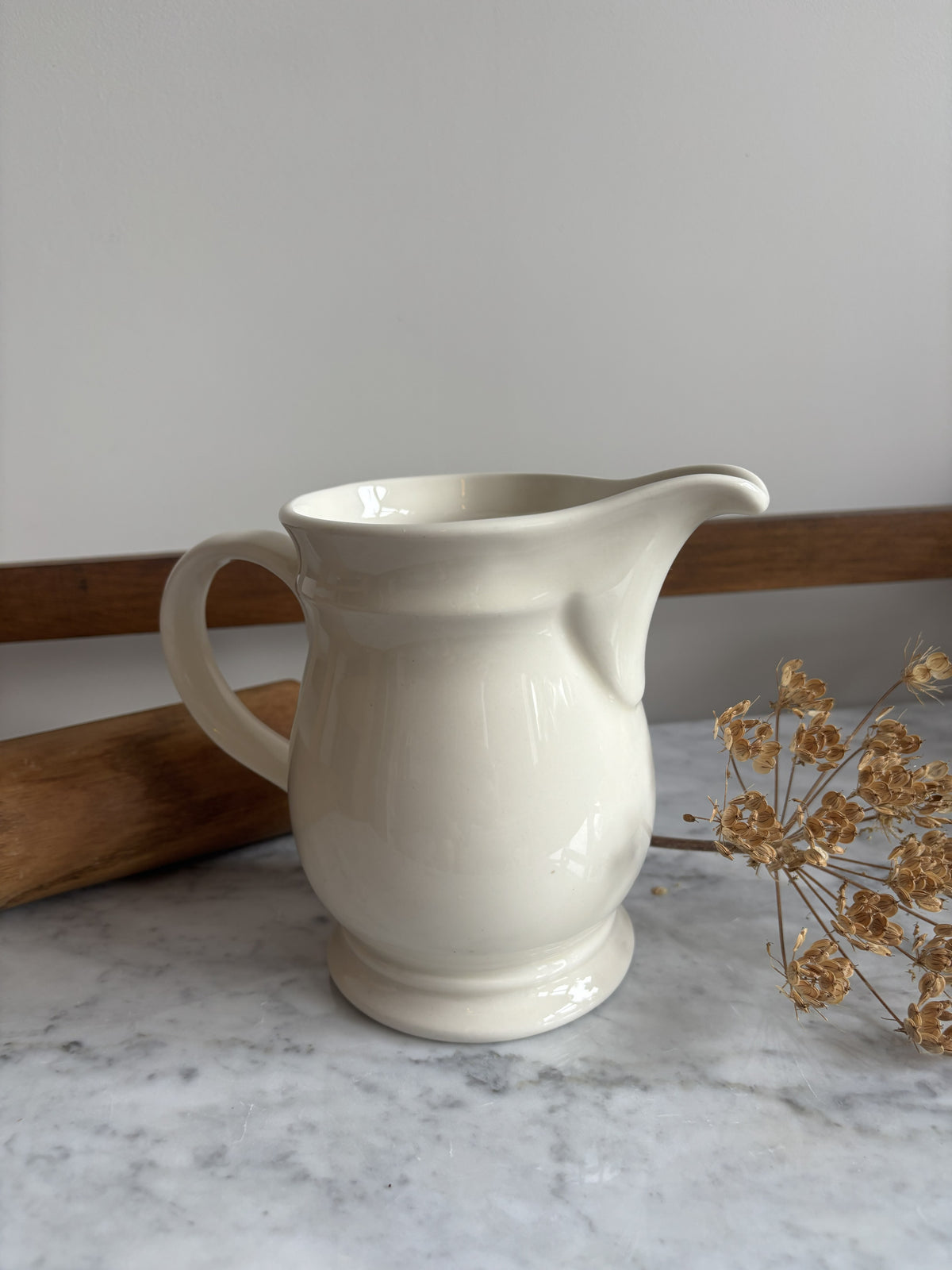 A white vintage milk jug