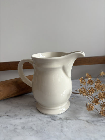 A white vintage milk jug