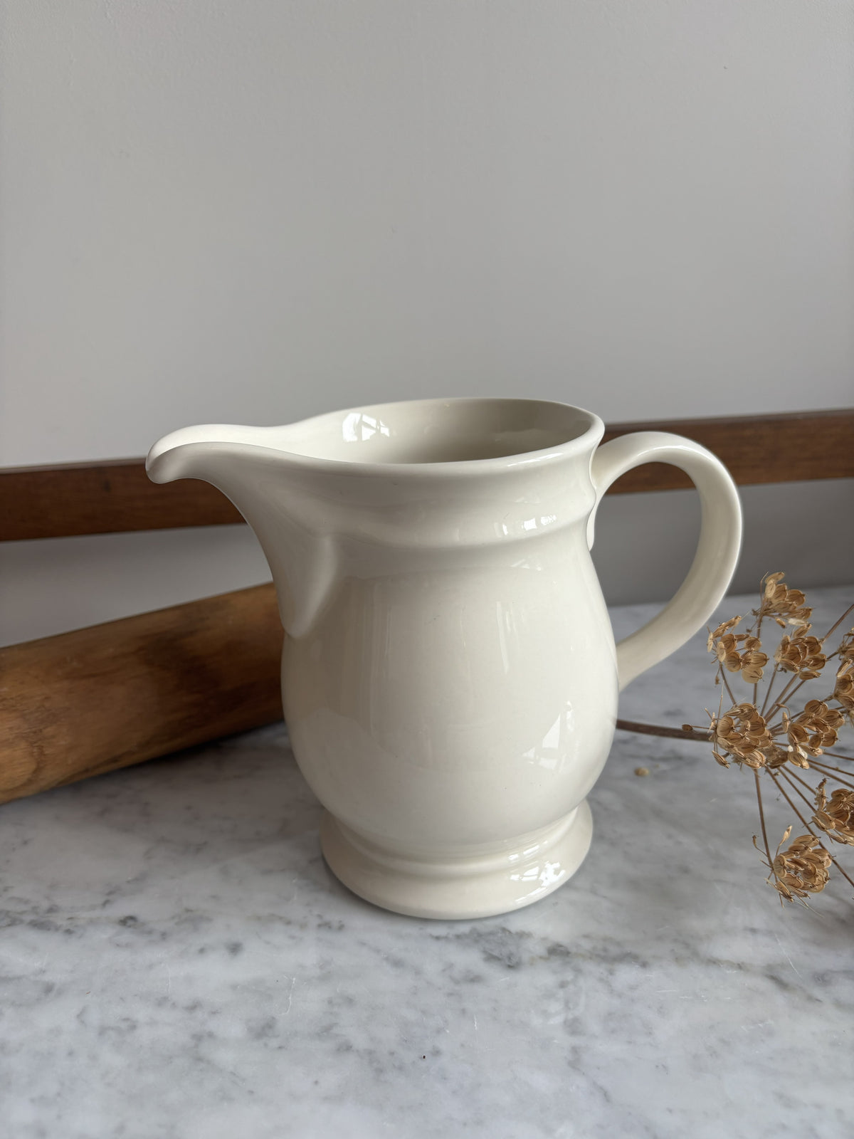 A white vintage milk jug