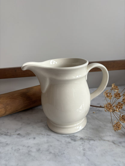 A white vintage milk jug