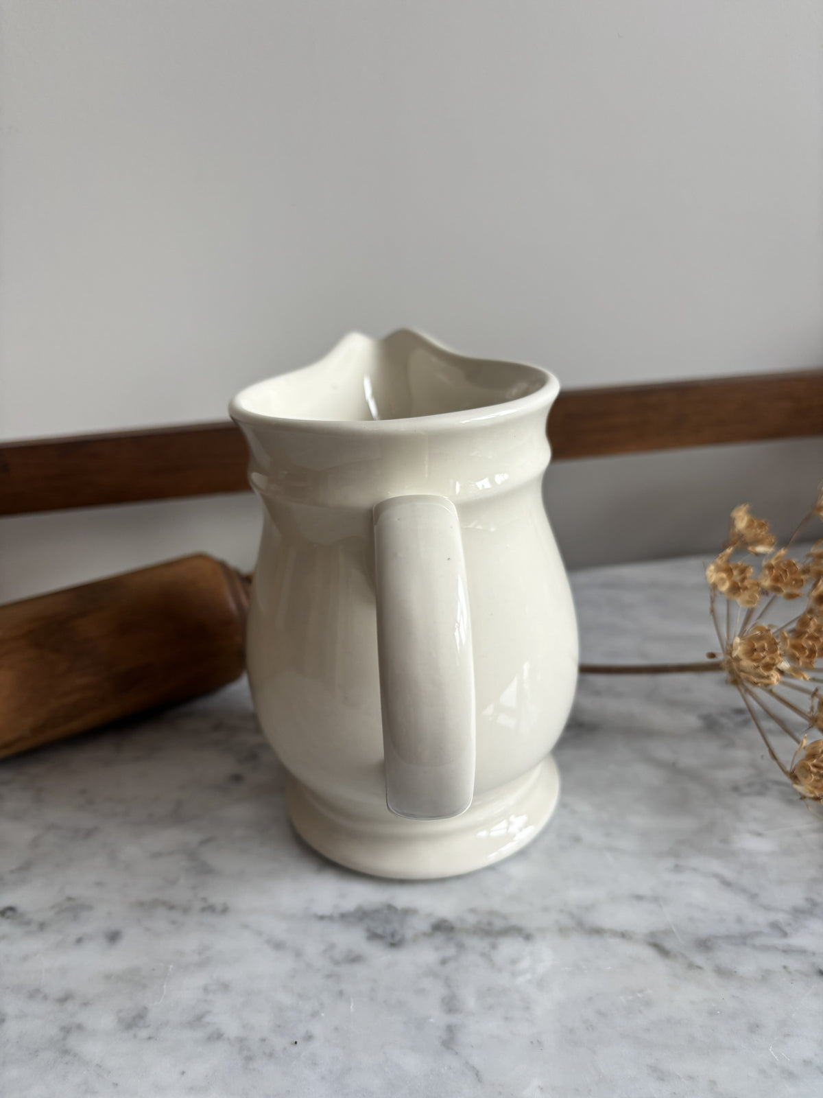 A white vintage milk jug
