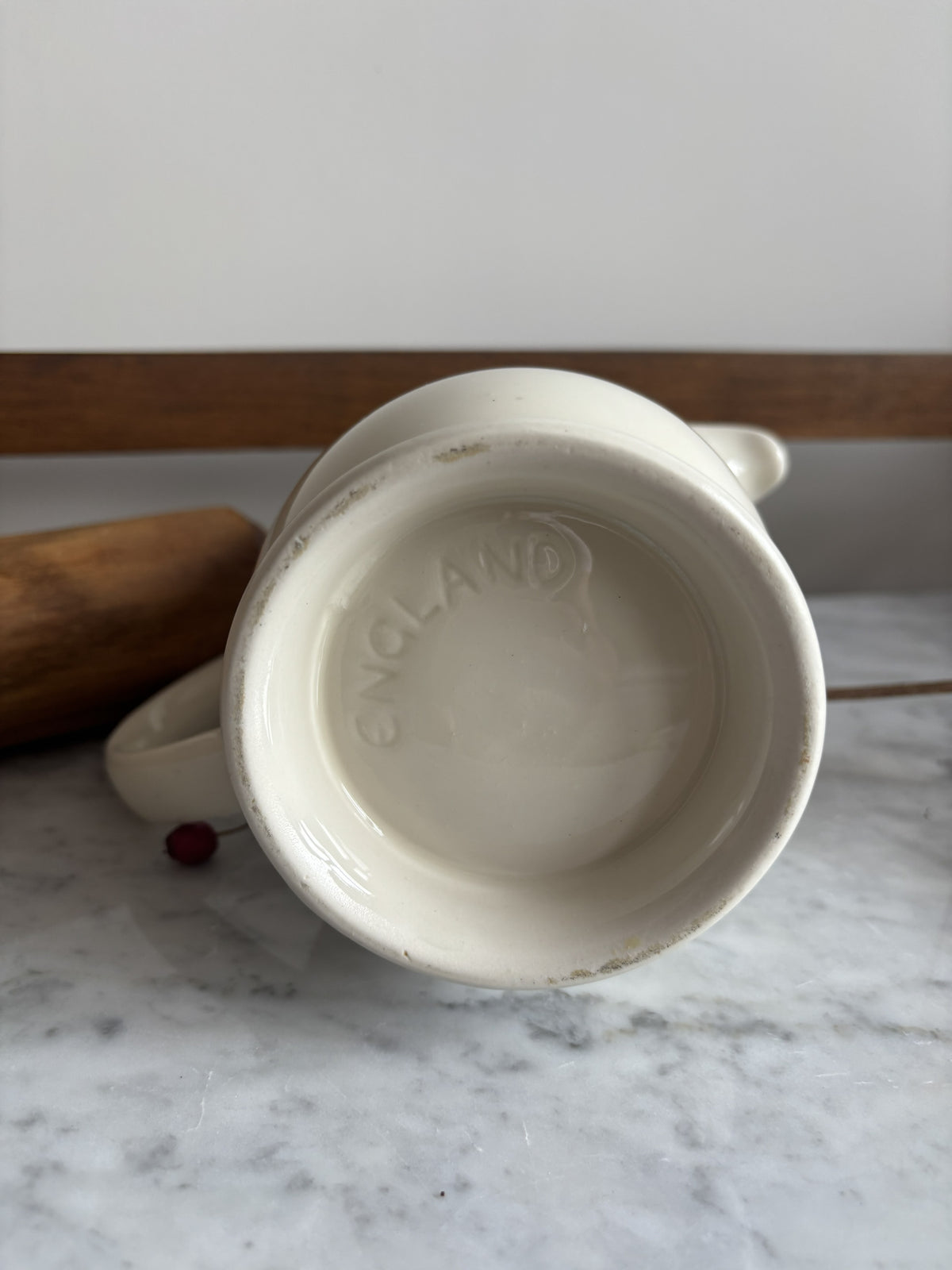 The base of a white vintage milk jug with the word England stamped on the bottom