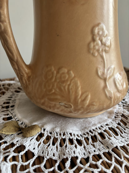 Vintage Price Bros art deco style beige jug with a cottage and floral 3D mould.  Close up of tiny flaw in finish.  