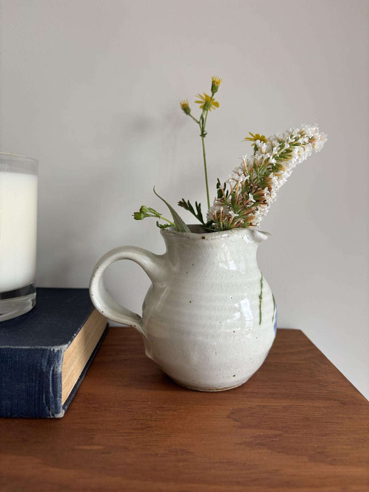 A small white bud vase