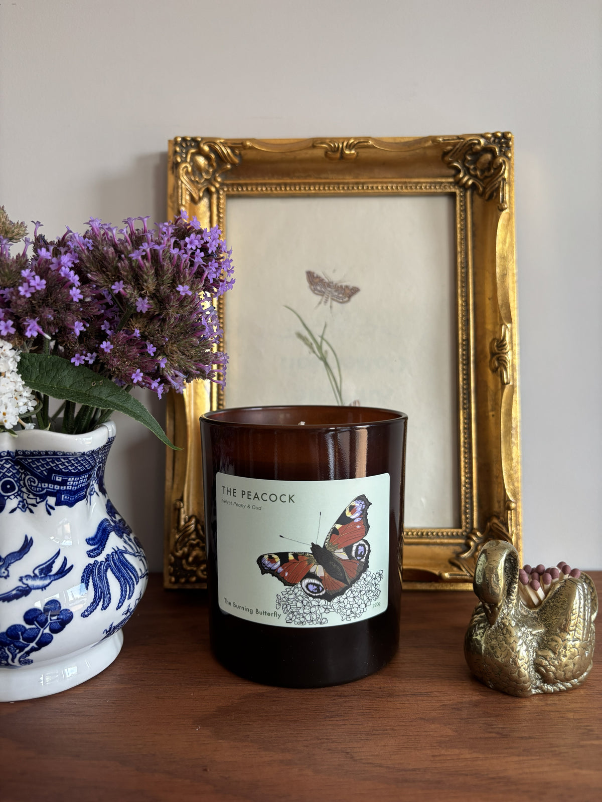The Peacock Scented Candle in amber glass - Velvet Peony and Oud | The Burning Butterfly