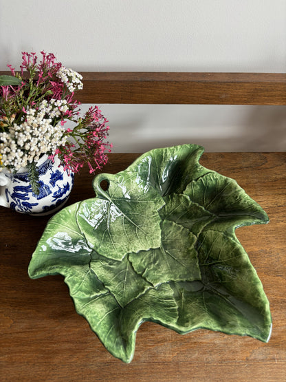 A green Vietri Foglia Majolica Style Leaf bowl featuring overlapping vines.  